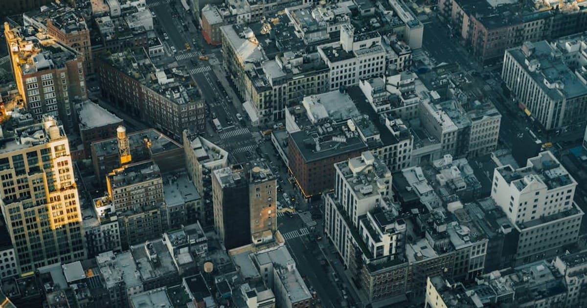A stunning aerial view showcasing the intricate rooftops and streets of New York City.
