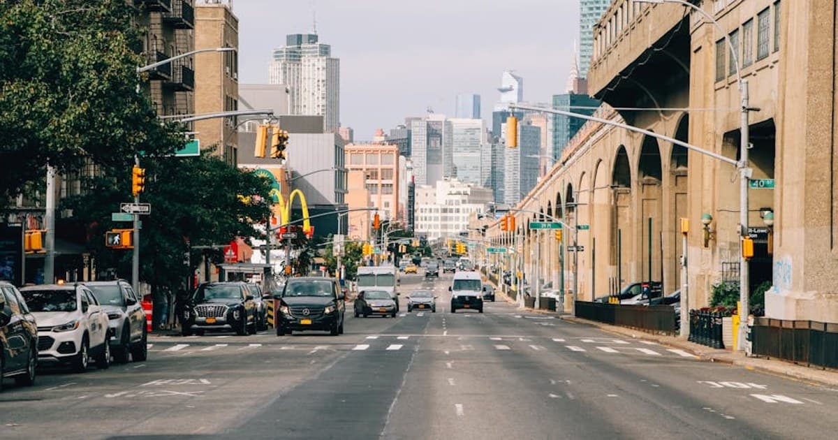 View of a busy street in New York City with skyscrapers and iconic landmarks in the background.
