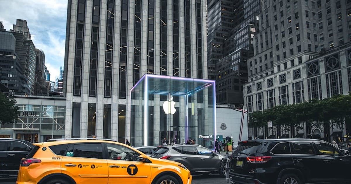 Iconic city scene of New York's Apple Store with bustling yellow taxi and urban skyline.
