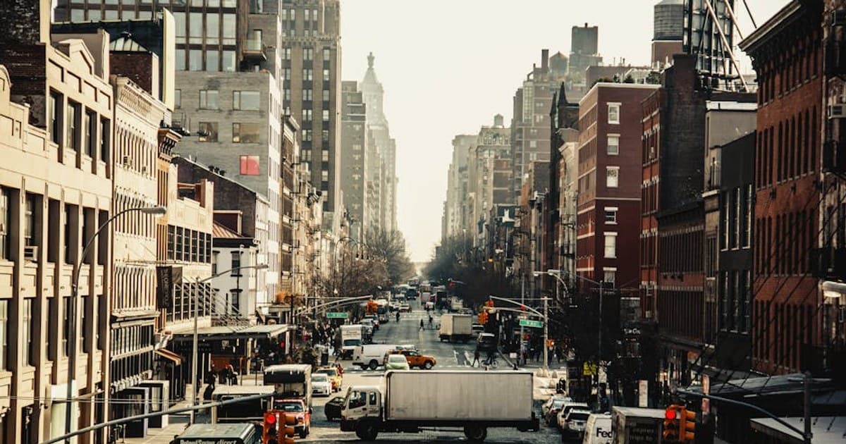 A bustling street in New York City filled with vehicles and iconic urban architecture.