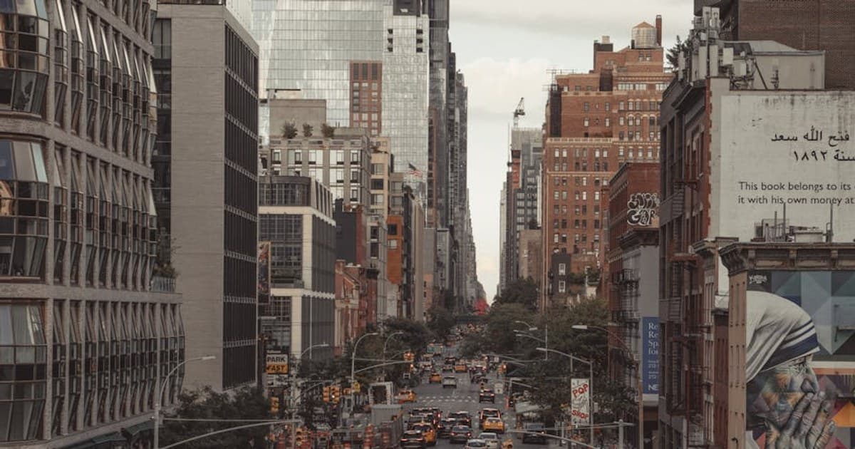 Vibrant street view of New York City with bustling traffic, tall skyscrapers, and urban life.
