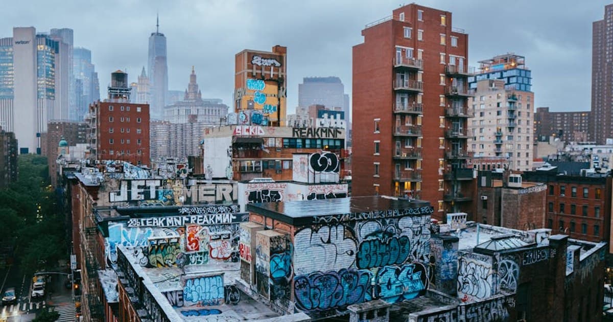 Dynamic scene of graffiti-covered rooftops in New York City's Manhattan.