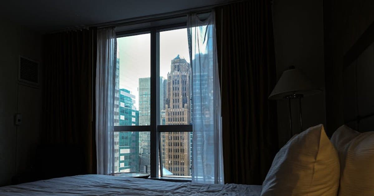 City view from a cozy hotel room in New York City, offering an urban skyline perspective.